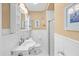 Bright bathroom showcasing the white tile, classic sink, and cabinet at 106 23Rd Ave, St Pete Beach, FL 33706