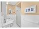 Well-lit bathroom showcasing the white tile, shower, and tasteful decor at 106 23Rd Ave, St Pete Beach, FL 33706