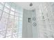Stylish bathroom shower enclosed with glass blocks and dual showerheads at 106 23Rd Ave, St Pete Beach, FL 33706