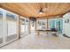 Bright sunroom with wood ceiling, tile floor, and windows to the back yard at 106 23Rd Ave, St Pete Beach, FL 33706