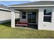 Outdoor back patio featuring a red picnic table, concrete floor, and sliding glass door at 11833 Clare Hill Ave, Riverview, FL 33579