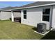 View of the backyard with lawn, patio, and air conditioning unit at 11833 Clare Hill Ave, Riverview, FL 33579