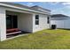 Backyard view showcasing a well-maintained lawn, white fence, and covered patio at 11833 Clare Hill Ave, Riverview, FL 33579