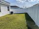 Large backyard featuring a green lawn and white fence at 11833 Clare Hill Ave, Riverview, FL 33579