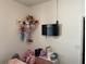 bedroom with mounted TV, storage shelves, and organized toys at 11833 Clare Hill Ave, Riverview, FL 33579