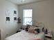 Cozy bedroom with white iron bedframe and unique decor at 11833 Clare Hill Ave, Riverview, FL 33579