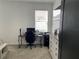 Bright bedroom features neutral walls, a light wood desk with computer, and modern accents at 11833 Clare Hill Ave, Riverview, FL 33579