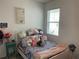 Cozy bedroom filled with decorative pillows and stuffed animals on the bed at 11833 Clare Hill Ave, Riverview, FL 33579