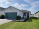 Inviting one-story home with a brick driveway and professionally landscaped front yard at 11833 Clare Hill Ave, Riverview, FL 33579