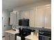 Kitchen features gray cabinets, quartz countertops, and stainless steel appliances, blending style with functionality at 11833 Clare Hill Ave, Riverview, FL 33579