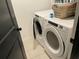 Laundry room features new washer and dryer units with overhead storage at 11833 Clare Hill Ave, Riverview, FL 33579