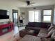 Spacious living area featuring a large sectional, fireplace, and access to the backyard at 11833 Clare Hill Ave, Riverview, FL 33579