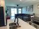 Open living room with a large sectional sofa, ceiling fan, and sliding glass doors to backyard at 11833 Clare Hill Ave, Riverview, FL 33579