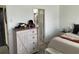 Neutral main bedroom offers a dresser, light walls, and ensuite bathroom at 11833 Clare Hill Ave, Riverview, FL 33579