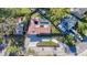 An aerial view showcases the home's tile roof, long driveway, and a screened pool with outdoor space at 1201 Kapok Kove Cir, Clearwater, FL 33759