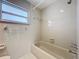 This bathroom features a tub and shower combination and a single window at 1201 Kapok Kove Cir, Clearwater, FL 33759