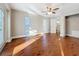 Primary bedroom features a ceiling fan, wood floors, ensuite bathroom, and a walk-in closet at 1201 Kapok Kove Cir, Clearwater, FL 33759