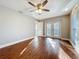 Bedroom with hard wood floors, ceiling fan, and access to the back yard at 1201 Kapok Kove Cir, Clearwater, FL 33759