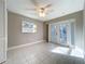 Bedroom featuring tile flooring, a ceiling fan and light and French doors at 1201 Kapok Kove Cir, Clearwater, FL 33759