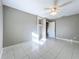 Bedroom with tile flooring, neutral paint, closet with shelving and a ceiling fan at 1201 Kapok Kove Cir, Clearwater, FL 33759