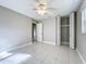 This bedroom features tile flooring, a ceiling fan and a closet with bi-fold doors at 1201 Kapok Kove Cir, Clearwater, FL 33759