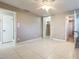 Bedroom with tiled floors, a ceiling fan, and a closet at 1201 Kapok Kove Cir, Clearwater, FL 33759