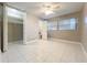 Bedroom with tiled floors, a ceiling fan, a closet and a window with blinds at 1201 Kapok Kove Cir, Clearwater, FL 33759