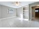 The bedroom includes tile flooring, neutral paint, a ceiling fan, closet, and a window at 1201 Kapok Kove Cir, Clearwater, FL 33759