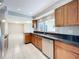 Well-lit kitchen with granite countertops, stainless steel appliances, and tile flooring at 1201 Kapok Kove Cir, Clearwater, FL 33759