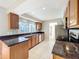 Modern kitchen with granite countertops, stainless steel appliances, and tile flooring at 1201 Kapok Kove Cir, Clearwater, FL 33759