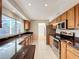Spacious kitchen featuring granite countertops, stainless steel appliances, and ample natural light at 1201 Kapok Kove Cir, Clearwater, FL 33759