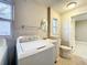 Combined laundry room and bathroom with washer and dryer, a sink and a toilet at 1201 Kapok Kove Cir, Clearwater, FL 33759