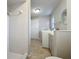 Combined laundry room and bathroom featuring a tiled shower and a washer and dryer at 1201 Kapok Kove Cir, Clearwater, FL 33759