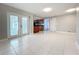 Living room features bright tile floors with access to outdoor patio via glass doors at 1201 Kapok Kove Cir, Clearwater, FL 33759