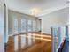 Sun-filled living area with hardwood floors and access to an outdoor area through glass doors at 1201 Kapok Kove Cir, Clearwater, FL 33759