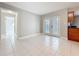 Living area features tile floors and french door access to the back patio and pool at 1201 Kapok Kove Cir, Clearwater, FL 33759