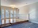 Bright living area with hardwood floors, and a decorative banister leading to the lower level at 1201 Kapok Kove Cir, Clearwater, FL 33759