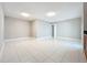 Spacious living room with white tile floors, light grey paint, and lots of natural light at 1201 Kapok Kove Cir, Clearwater, FL 33759