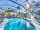 A screened in pool provides the perfect private place to relax and enjoy the sunshine at 1201 Kapok Kove Cir, Clearwater, FL 33759