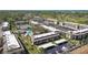 Aerial shot showcases well-maintained condos, green spaces, parking, tennis courts, and the community pool at 12300 Vonn Rd # 2204, Largo, FL 33774