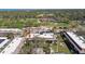Aerial photo showcases complex, manicured golf course, trees, and community amenities in beautiful sunny weather at 12300 Vonn Rd # 2204, Largo, FL 33774
