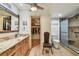 Well-organized bathroom with granite countertops, a walk-in shower, and an adjacent walk-in closet at 12300 Vonn Rd # 2204, Largo, FL 33774