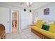 Bright bedroom with futon, tile floors, closet, and door to bathroom with commode at 12300 Vonn Rd # 2204, Largo, FL 33774