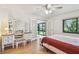 Well-lit bedroom featuring hardwood floors, a vanity table with a mirror, and a comfortable bench at 12300 Vonn Rd # 2204, Largo, FL 33774
