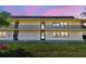 Condo exterior view showing balconies, lush lawn, and easy access to units at 12300 Vonn Rd # 2204, Largo, FL 33774