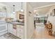 Bright kitchen with white cabinetry open to the living area, with view to exterior at 12300 Vonn Rd # 2204, Largo, FL 33774