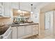 Kitchen view overlooking the dining and living area with a clean white design at 12300 Vonn Rd # 2204, Largo, FL 33774