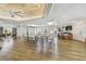 Large meeting room with plenty of seating, laminate floors, and a ceiling fan at 12300 Vonn Rd # 2204, Largo, FL 33774