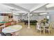 Spacious recreation room featuring various game tables, chairs, and plenty of room to entertain guests at 12300 Vonn Rd # 2204, Largo, FL 33774