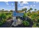 Villas de Golf community sign surrounded by lush landscaping and blue skies at 12300 Vonn Rd # 2204, Largo, FL 33774